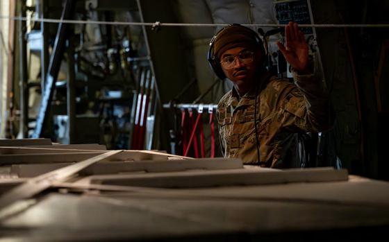 Photo Of U.S. Air Force Senior Airman Milo Carter, 374th Operations Support Squadron instructor loadmaster, directs Airmen pushing cargo into a C-130 Hercules at Misawa Air Base, Japan, Jan. 14, 2025.