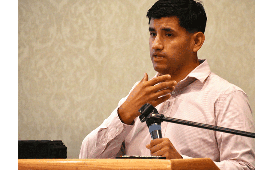 Julio Escareno, U.S. Army Criminal Investigation Command (commonly known as CID) special agent in charge at Camp Zama, gestures toward his throat while talking about strangulation and suffocation during the Family Advocacy Program’s senior leader domestic violence symposium at the Camp Zama Community Club, Camp Zama, Japan, Oct. 4, 2019.