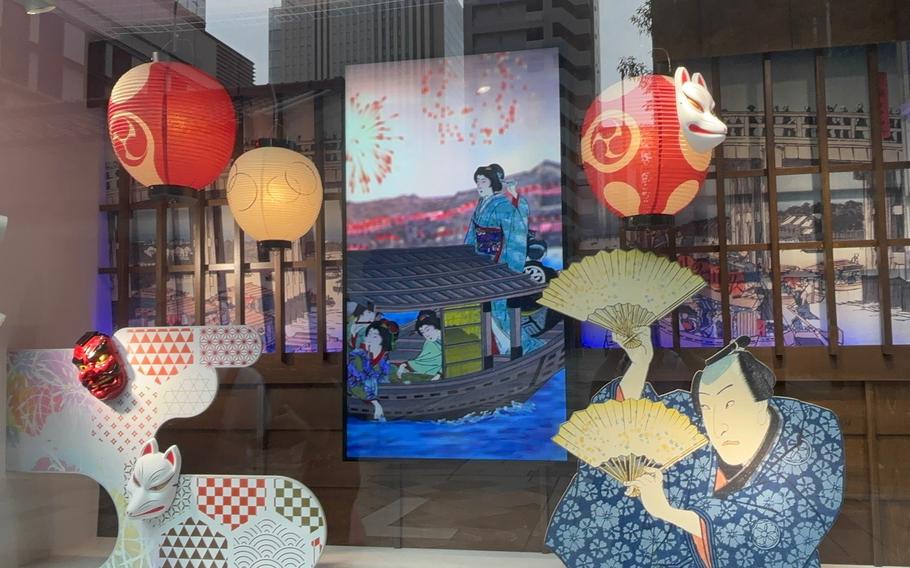A shop displaying Japanese traditional picture, lanterns, fox mask, and daruma mask