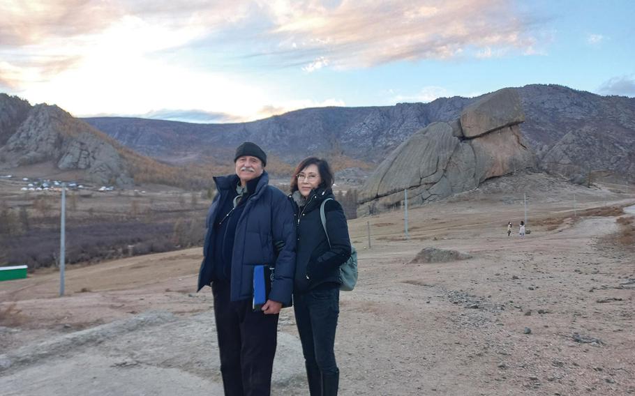 Author with wife standing lonely amid the deserted landscape