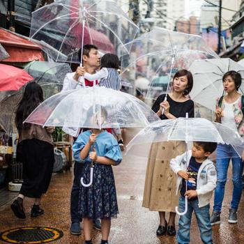 A family using umbrellas in Harajuku on a rainy day.