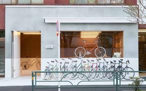 many bicycles parked in front of shop