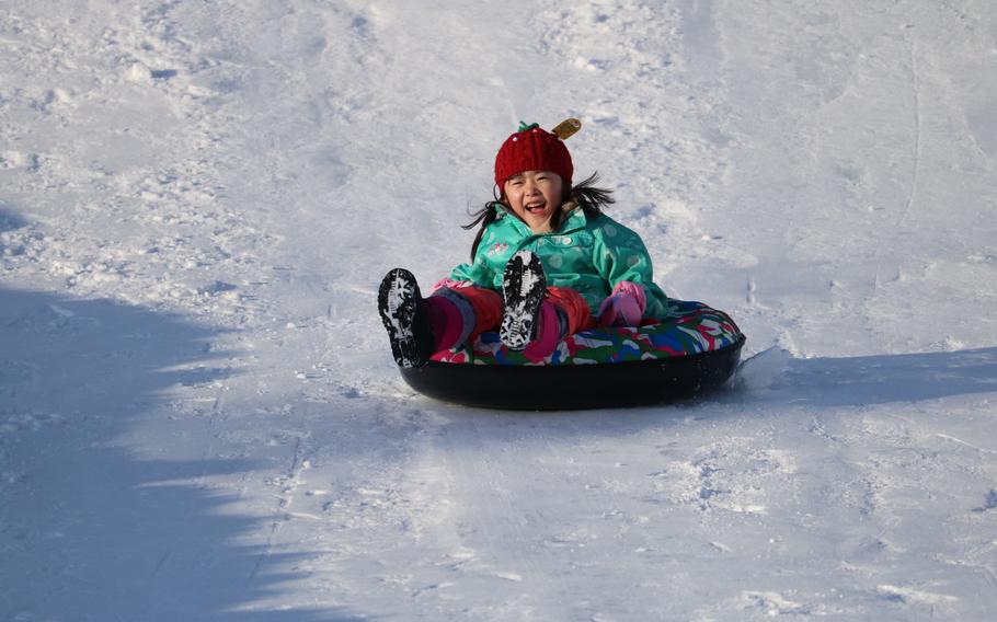 a child enjoys sledding