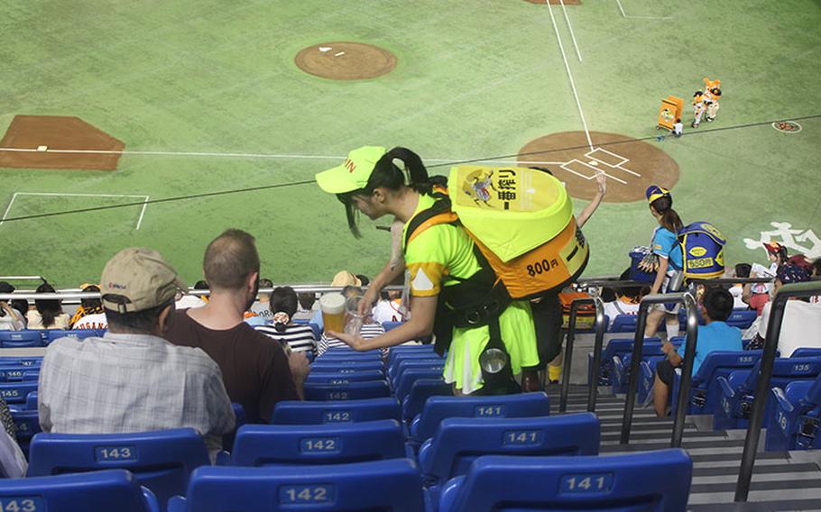 a beer girl serving beer at Tokyo Dome