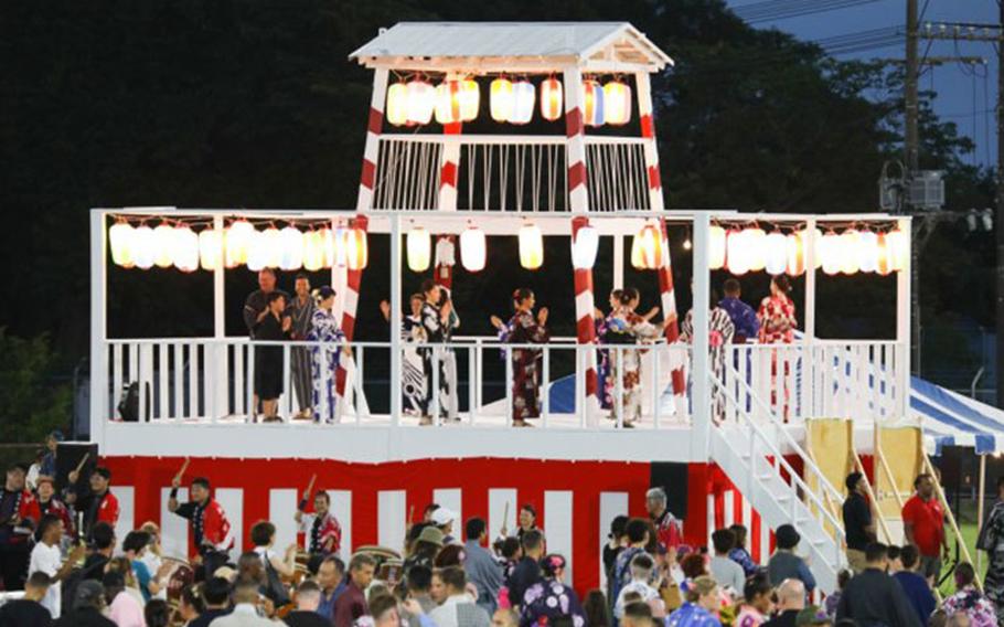 Bon Odori festival attendees dance on and around a bon tower at Camp Zama, Japan, Aug. 5, 2023. About 20,000 people attended this year's event, which honors the departed spirits of one’s ancestors. The traditional Japanese festival has been celebrated at Camp Zama since 1959. (Photo Credit: Sean Kimmons)