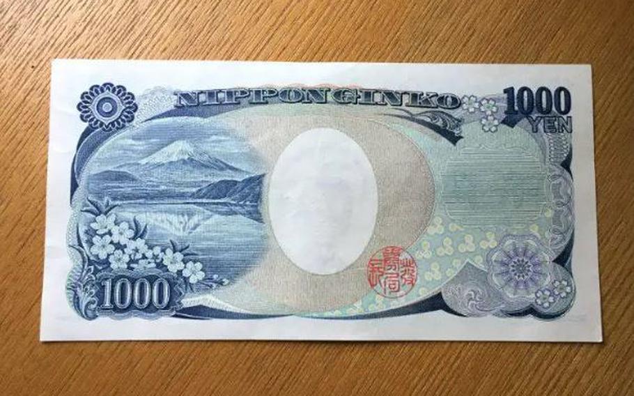 The backside of the 1,000-yen bill shows Mount Fuji Upside-down together with cherry blossoms.