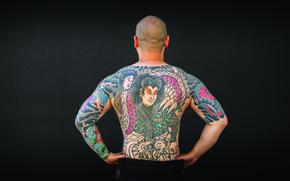 tattoos on a man’s back