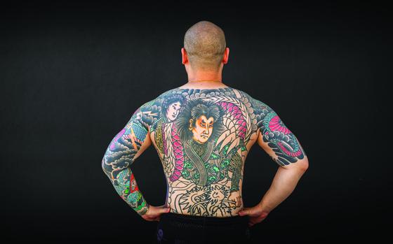 Photo Of tattoos on a man’s back