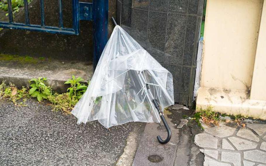 Broken umbrella left on the street