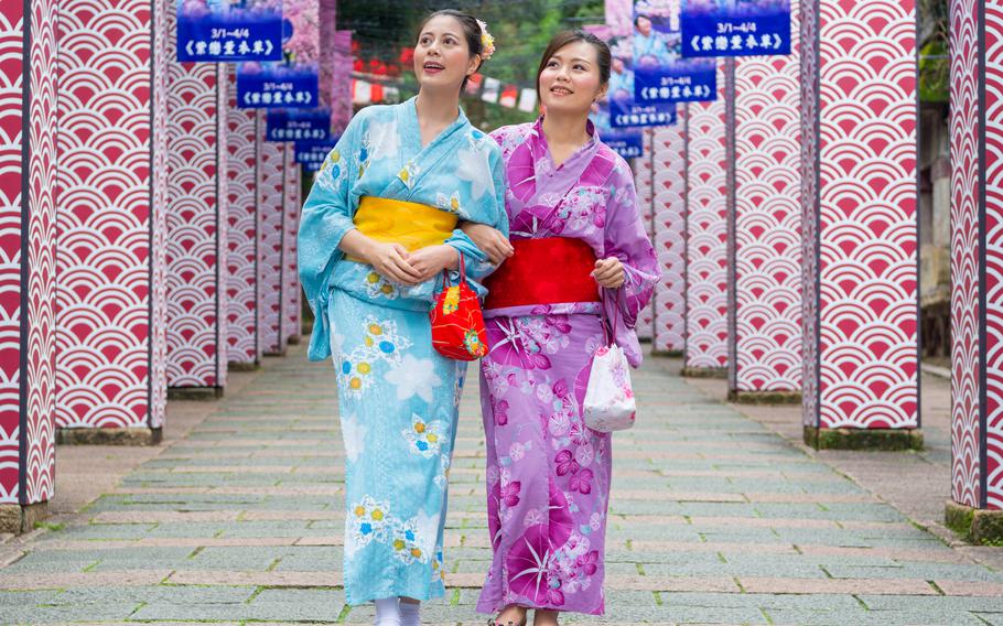 women wearing traditional clothing dress kimono joining japanese festival celebration together and walking on history pathway viewing japan culture in summer vacation.