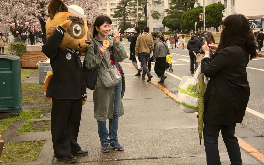 festival attendee posing for a photo with a mascot at Yokosuka Spring Festival