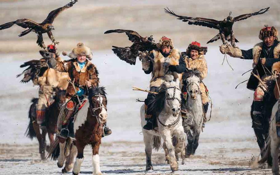 Mongolians riding horses