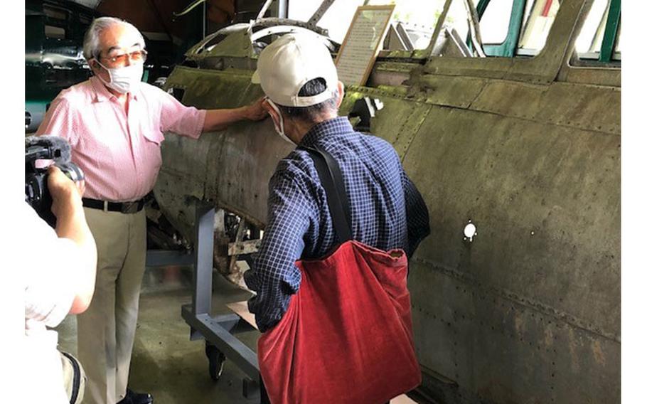 Mr. Nobuo Harada explaining his MYRT restoration plans to media representative on Press Day at his Kawaguchiko Aviation Museum on Saturday, July 31, 2021 (photo by Michael Ryan)