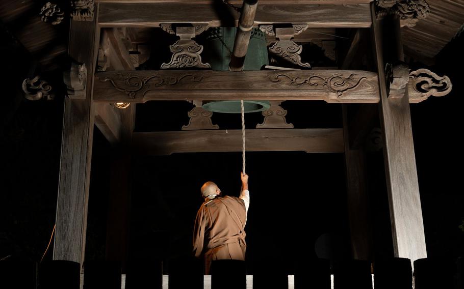 A monk ringing a bell to celebrate the new year