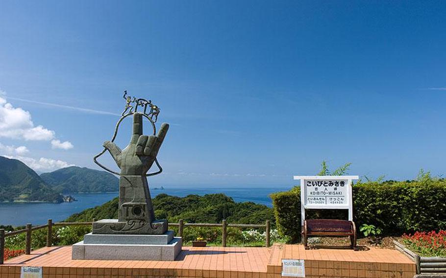 arm-shaped statue can be seen on the hill.