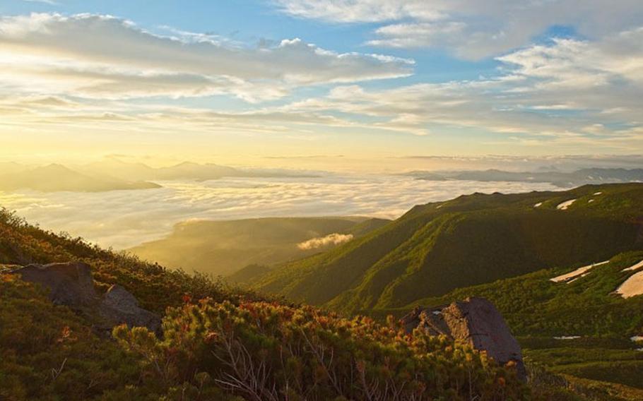 The golden light of the sunrise light up the cloud covered valley. Photo: Sandro Bernardinello