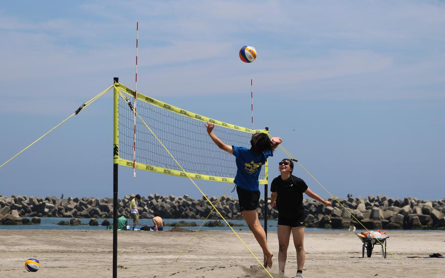People playing beach volleyball.