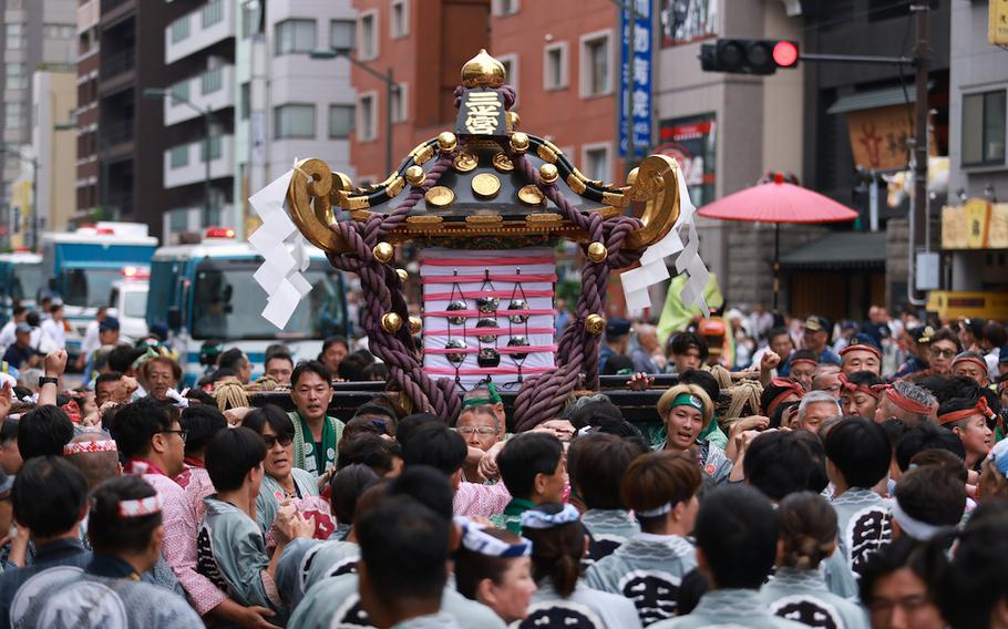 Festival attendees carrying mikoshi (portable shrine).